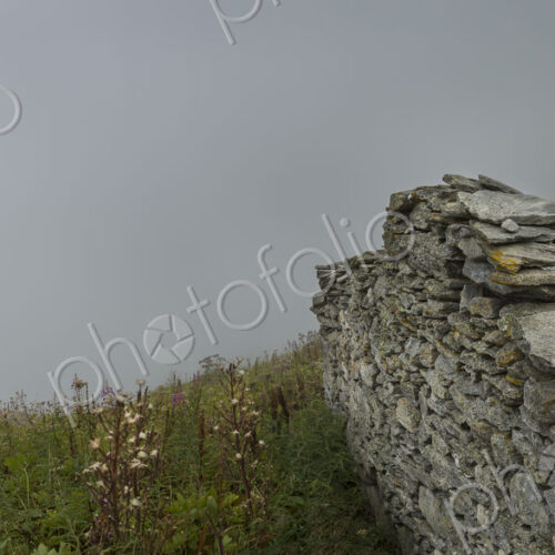A mountain shrine by the path in the Alpine region near Mont Blanc, a cross near… A mountain shrine by the path in the Alpine region near Mont Blanc, a cross near…
