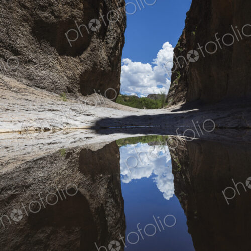 A narrow slot canyon with a mirror reflection in the water near Lajitas. A narrow slot canyon with a mirror reflection in the water near Lajitas.