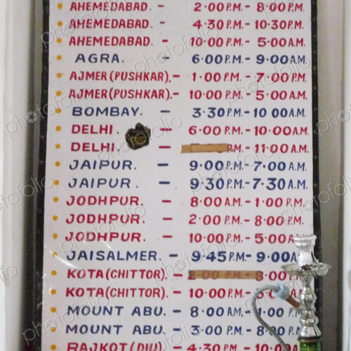 A noticeboard, a bus schedule for public transport in India.