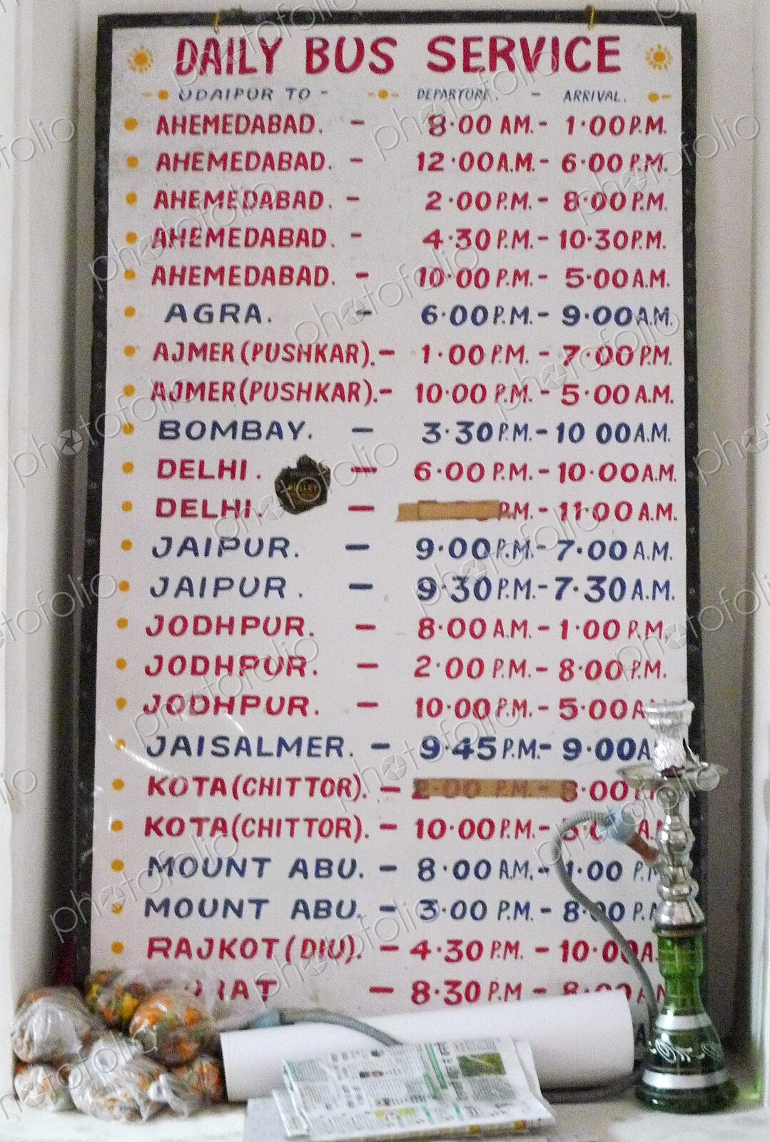 A noticeboard, a bus schedule for public transport in India.