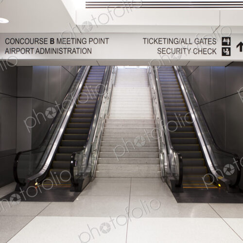 A pair of escalators and information signs