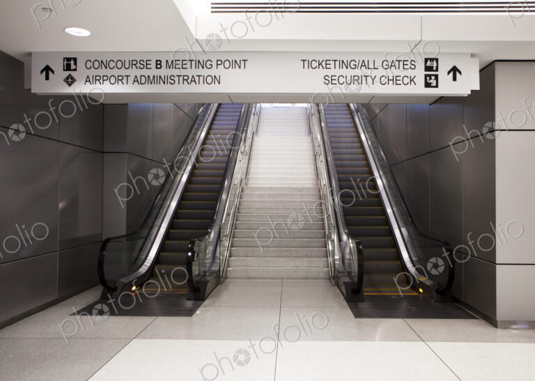 A pair of escalators and information signs