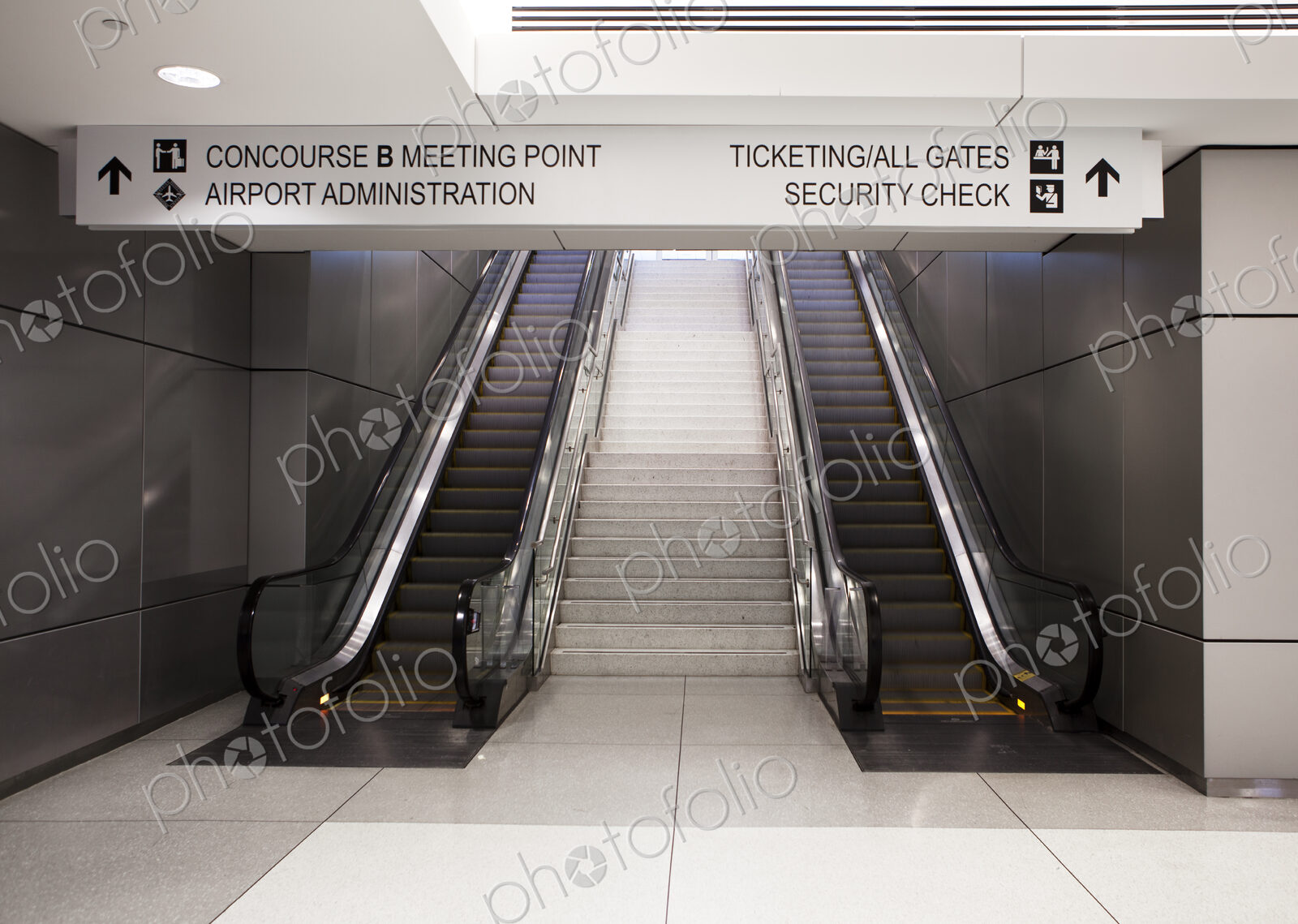 A pair of escalators and information signs