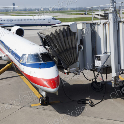 A passenger aircraft and connected passenger boarding tunnel or airbridge