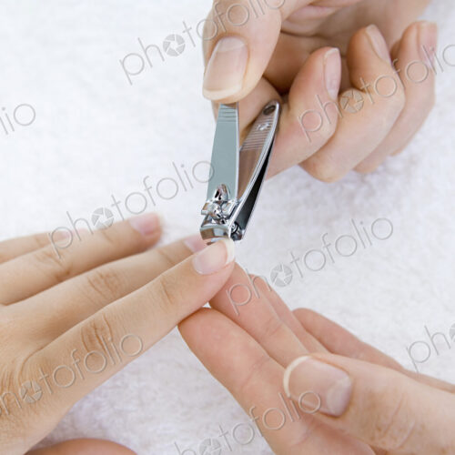 A person having a nail manicure. A person having a nail manicure.