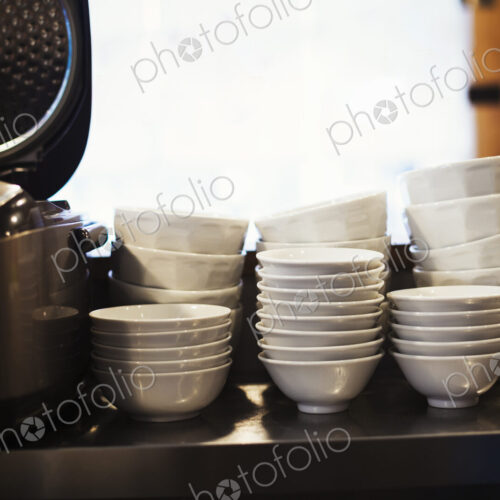 A pile of bowls on a noodle shop counter. A pile of bowls on a noodle shop counter.