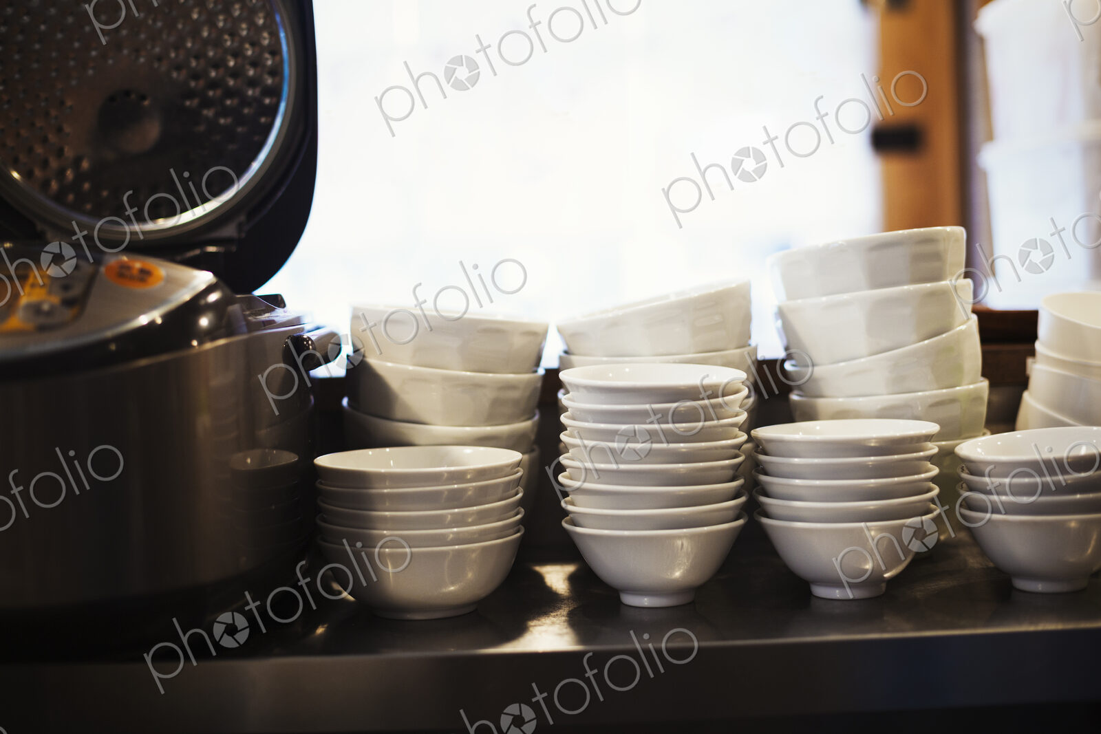 A pile of bowls on a noodle shop counter.
