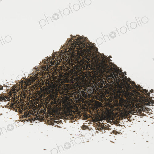 A pile of organic compost on a white background. A pile of organic compost on a white background.