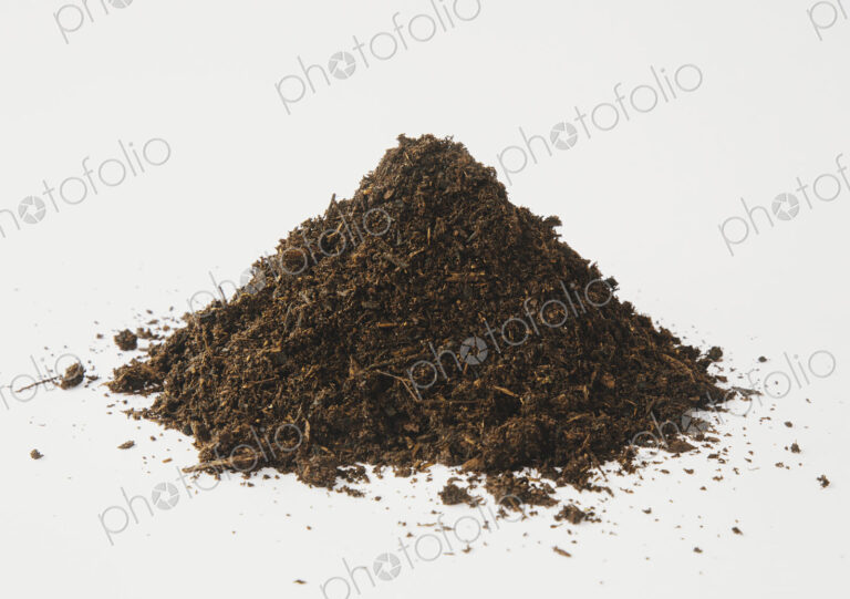 A pile of organic compost on a white background.