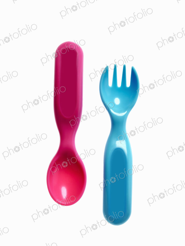 A pink plastic baby spoon and a blue fork.