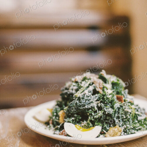 A plate of cooked vegetables and soft boiled eggs, with garnishes. A plate of cooked vegetables and soft boiled eggs, with garnishes.
