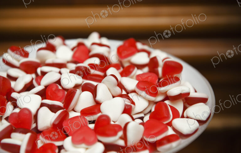 A plate of red and white heart-shaped sweets.