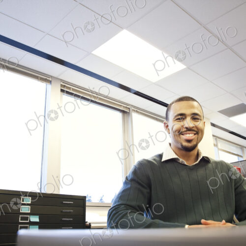A portrait of a Black businessman in his corporate office. A portrait of a Black businessman in his corporate office.