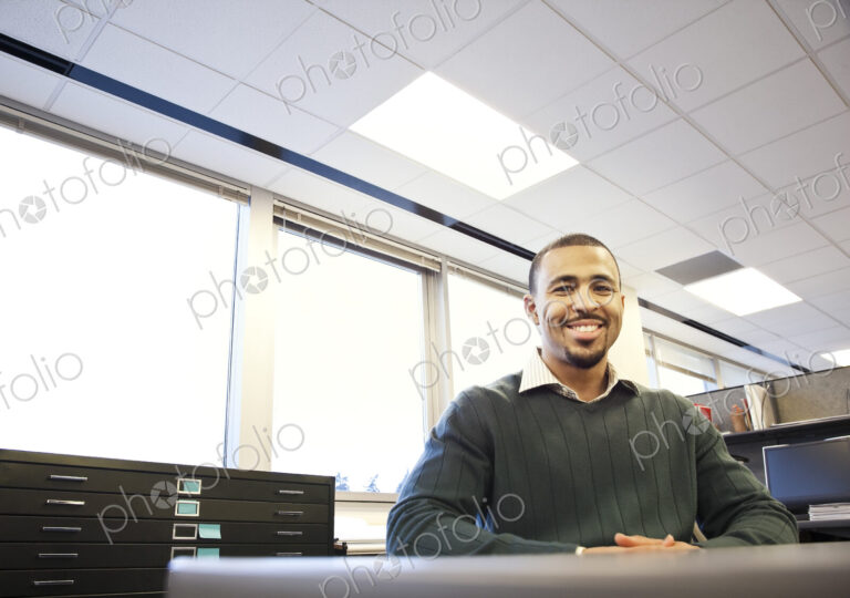 A portrait of a Black businessman in his corporate office.