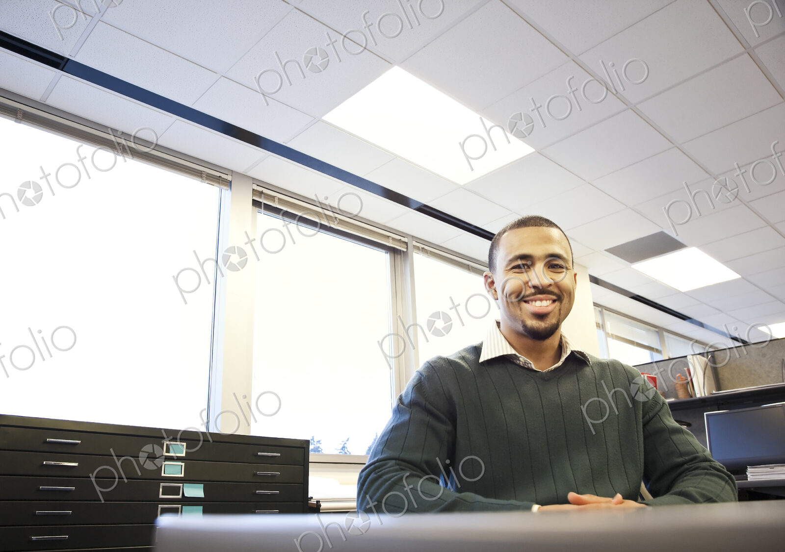 A portrait of a Black businessman in his corporate office.