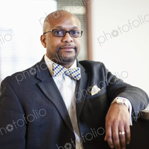 A portrait of a black businessman in a suit and bow tie. A portrait of a black businessman in a suit and bow tie.