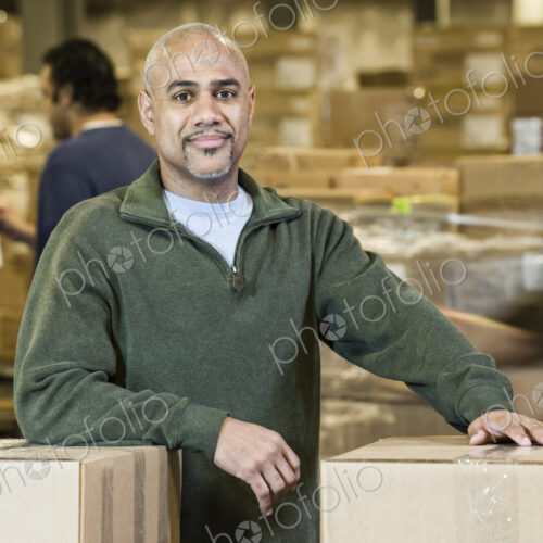 A portrait of a black warehouse business manager. surrounded by storage boxes and… A portrait of a black warehouse business manager. surrounded by storage boxes and…