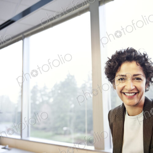 A portrait of a businesswoman in her office.