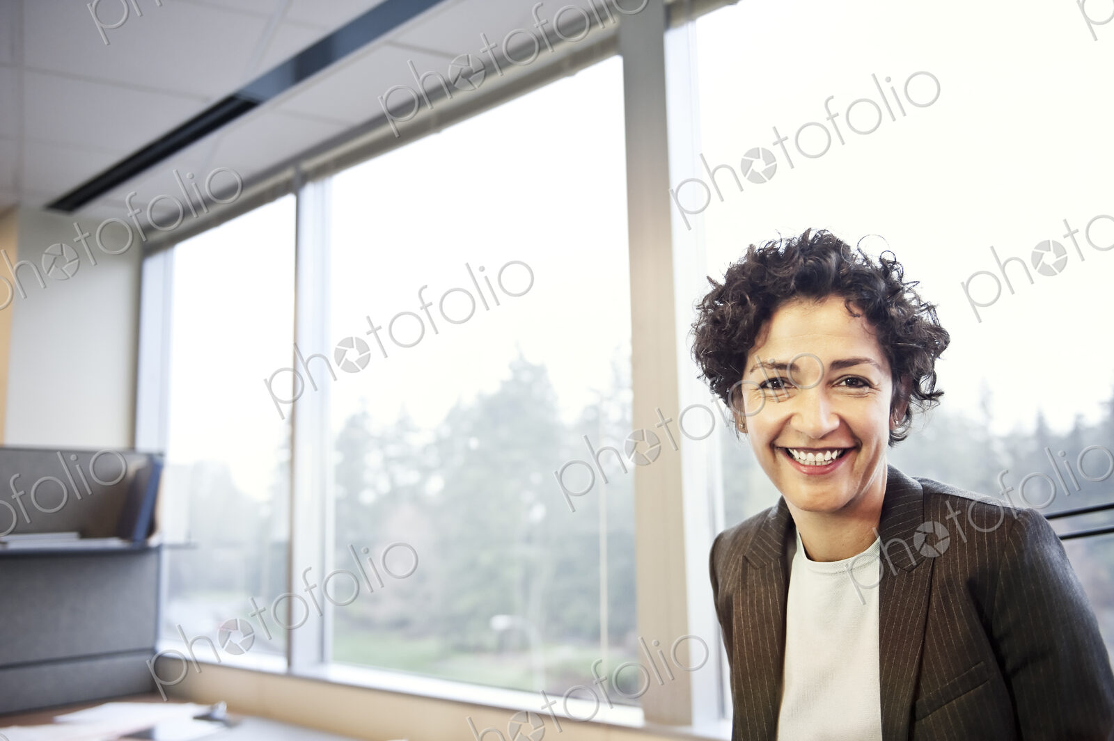 A portrait of a businesswoman in her office.