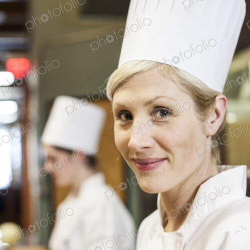 A portrait of a caucasian female chef in a commercial kithchen. A portrait of a caucasian female chef in a commercial kithchen.