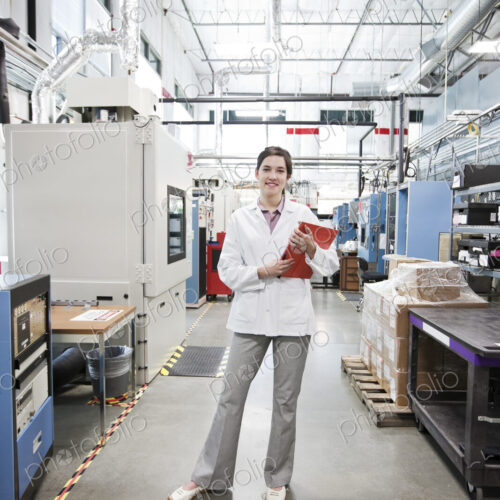 A portrait of a caucasian female technician in a technical research and development site. A portrait of a caucasian female technician in a technical research and development site.