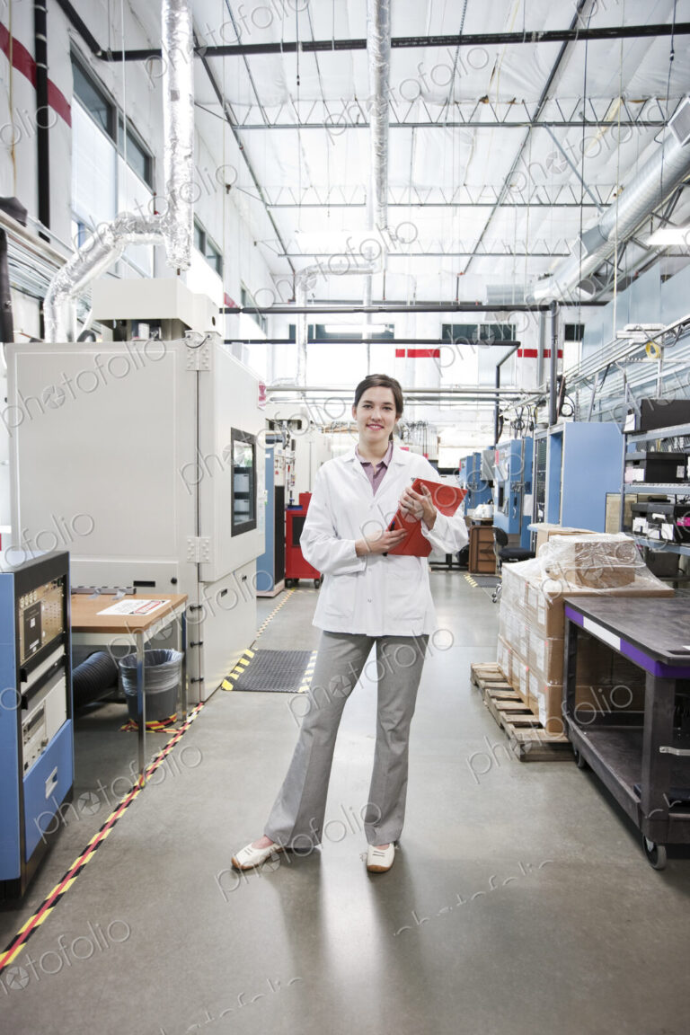 A portrait of a caucasian female technician in a technical research and development site.