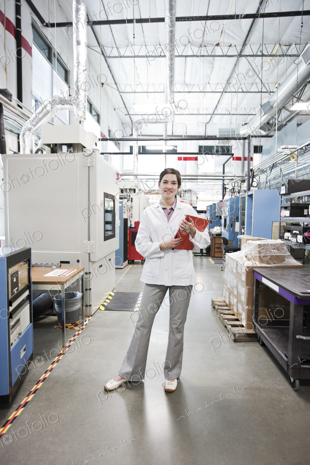 A portrait of a caucasian female technician in a technical research and development site.