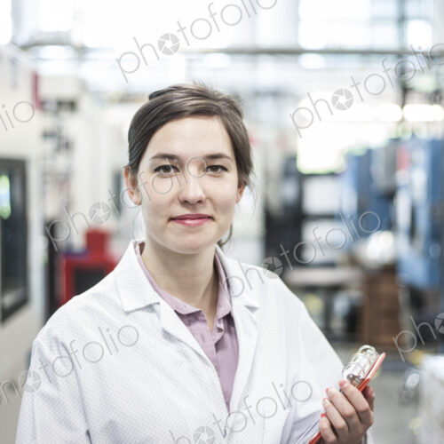A portrait of a caucasian female technician in a technical research and development site. A portrait of a caucasian female technician in a technical research and development site.