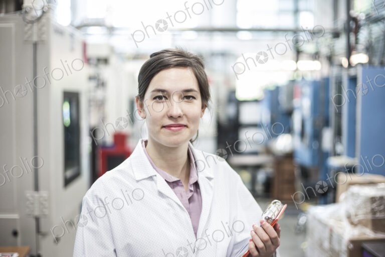 A portrait of a caucasian female technician in a technical research and development site.
