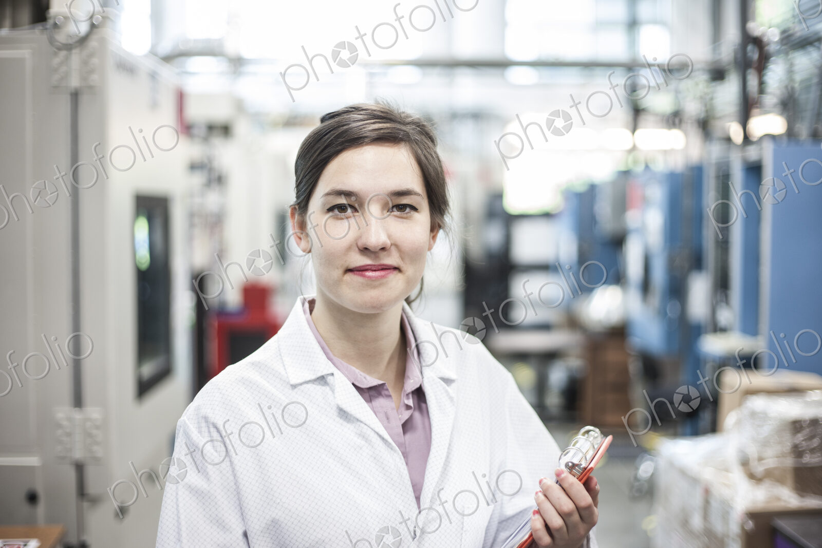 A portrait of a caucasian female technician in a technical research and development site.