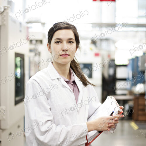 A portrait of a caucasian female technician in a technical research and development site. A portrait of a caucasian female technician in a technical research and development site.