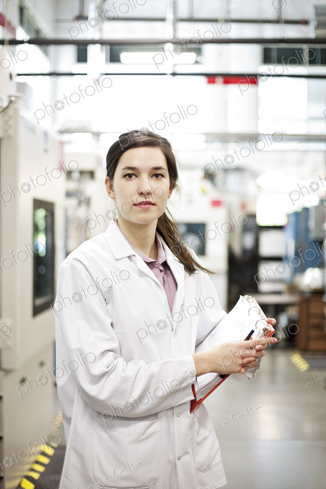 A portrait of a caucasian female technician in a technical research and development site.