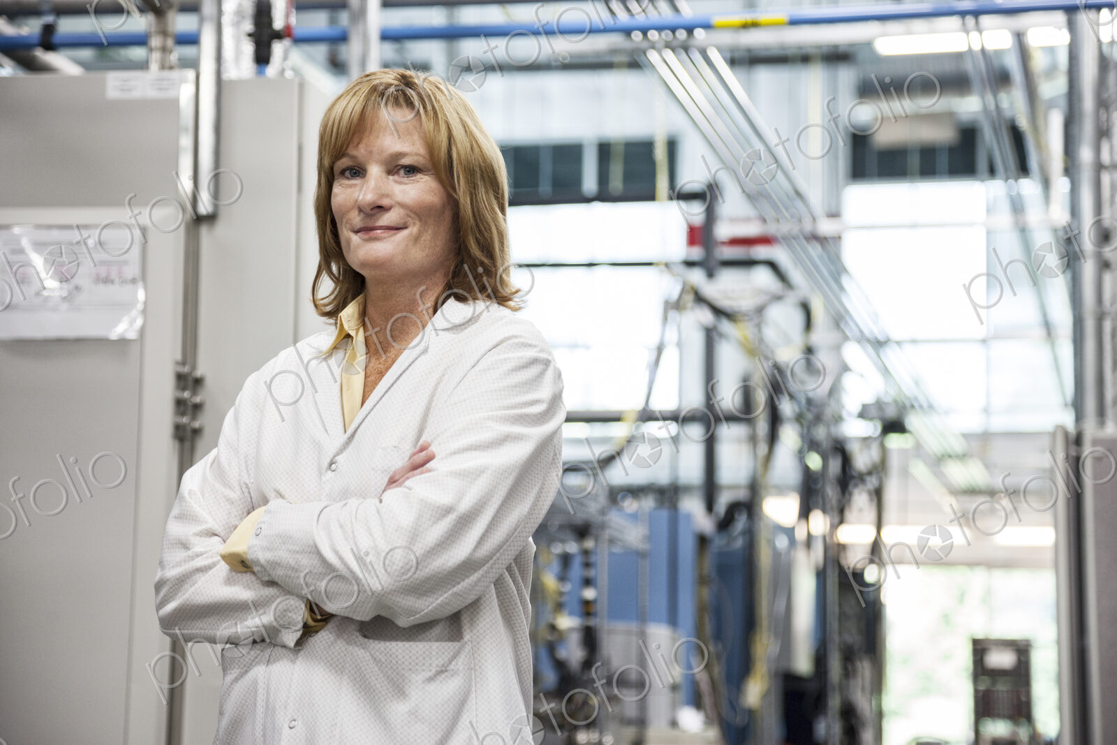 A portrait of a caucasian female technician in a technical research and development site.