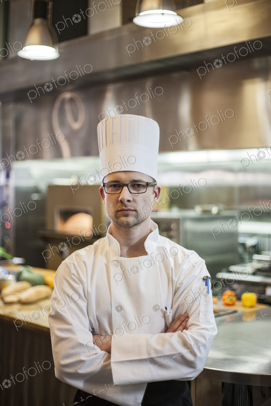 A portrait of a caucasian male chef in a commercial kitchen.
