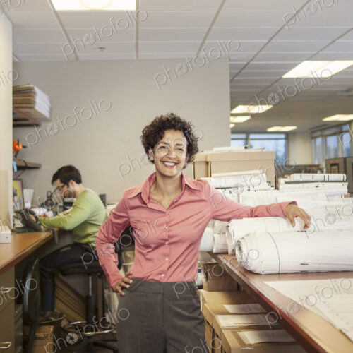 A portrait of a female architect in her office. A portrait of a female architect in her office.