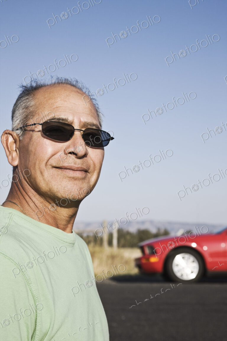 A portrait of a hip senior Hispanic male on a road trip.