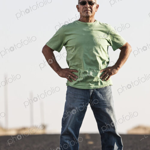 A portrait of a hip senior Hispanic male on a road trip.