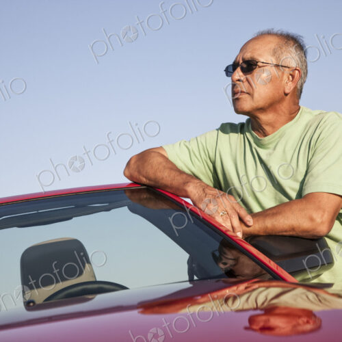 A portrait of a hip senior Hispanic male on a road trip.