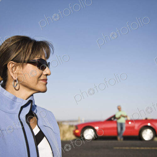 A portrait of a hip senior Hispanic woman on a road trip with her husband. A portrait of a hip senior Hispanic woman on a road trip with her husband.