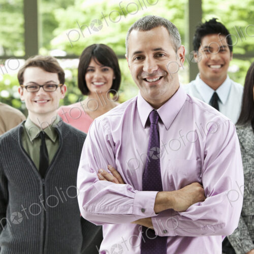 A portrait of a mixed race team of business people with a Caucasian businessman in the… A portrait of a mixed race team of business people with a Caucasian businessman in the…