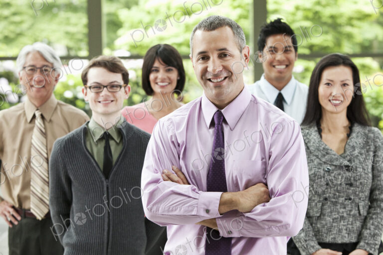 A portrait of a mixed race team of business people with a Caucasian businessman in the…