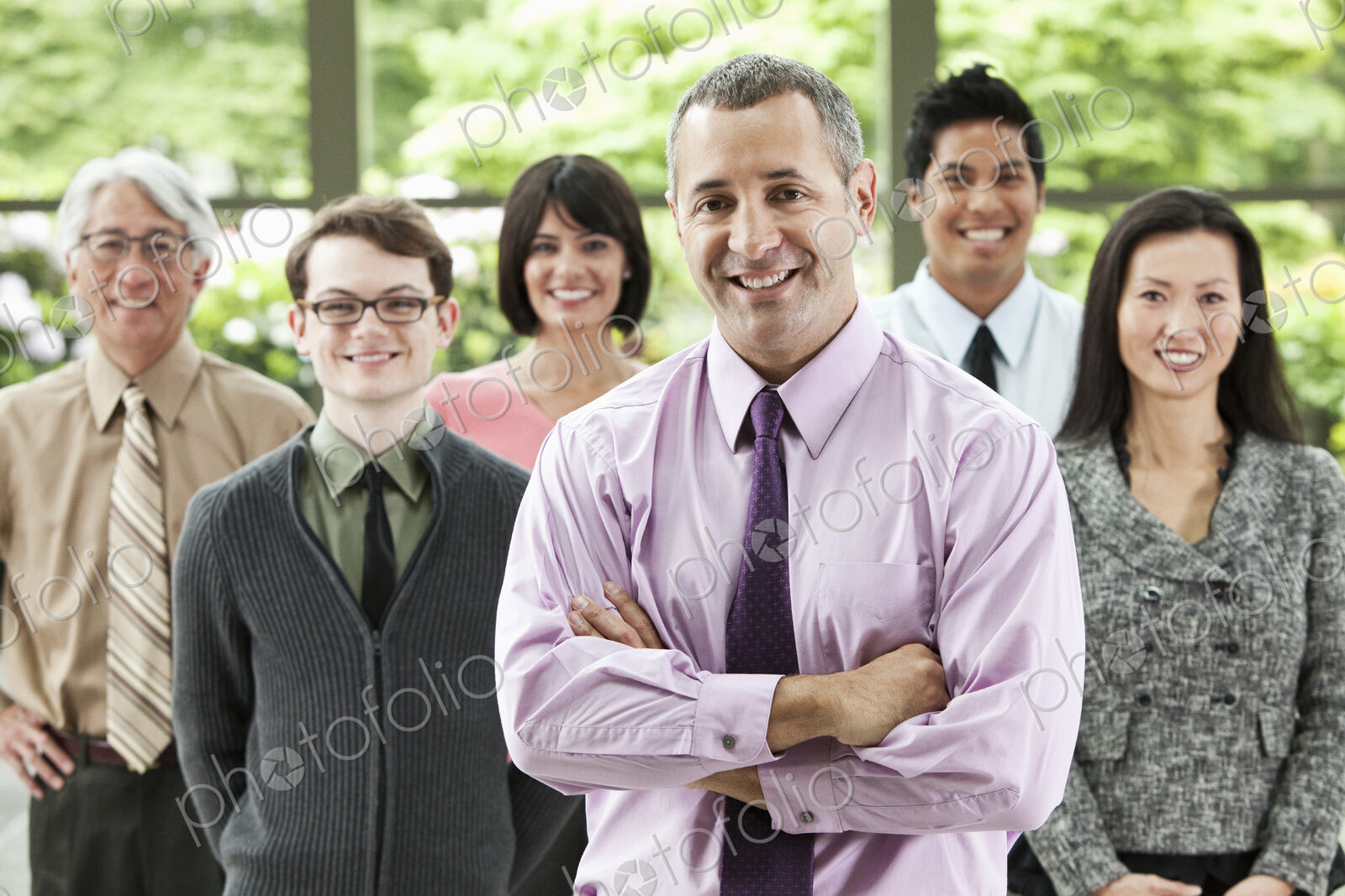 A portrait of a mixed race team of business people with a Caucasian businessman in the…