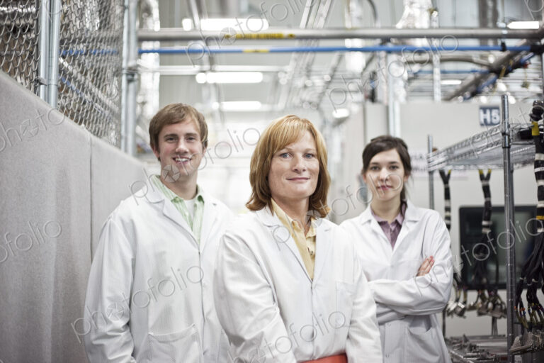A portrait of a team of technicians in a technical research and development site.