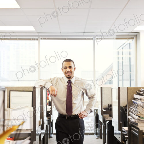 A portrait of a young Black businessman in his corporate office. A portrait of a young Black businessman in his corporate office.