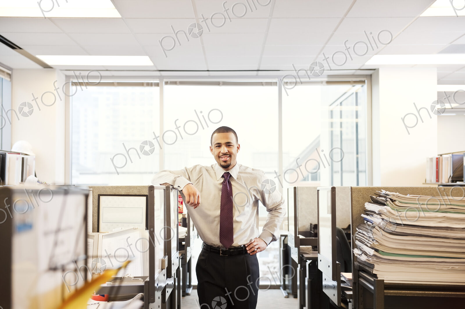 A portrait of a young Black businessman in his corporate office.