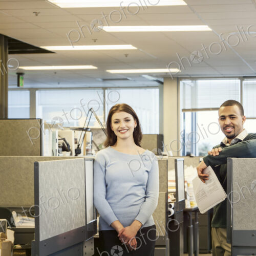A portrait of a young Caucasian business woman and Black businessman in their…