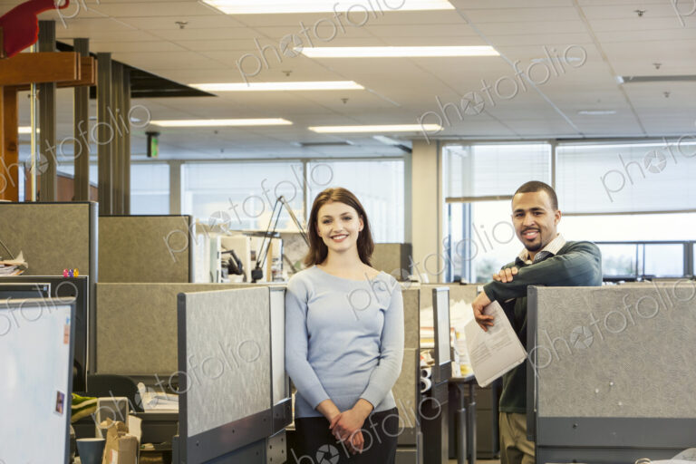 A portrait of a young Caucasian business woman and Black businessman in their…