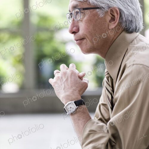 A portrait of an Asian businessman in a convention center setting. A portrait of an Asian businessman in a convention center setting.