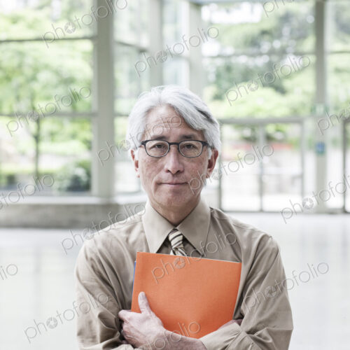 A portrait of an Asian businessman in a convention center setting. A portrait of an Asian businessman in a convention center setting.