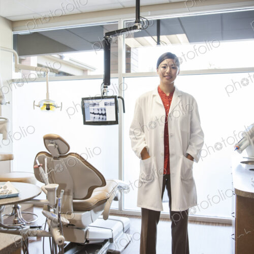 A portrait of an Asian female dentist in her office. A portrait of an Asian female dentist in her office.